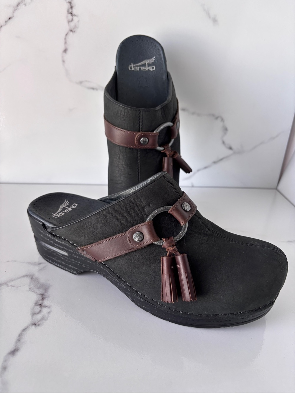 Dansko Black Leather women's Slip-On Clogs with Brown Tassels